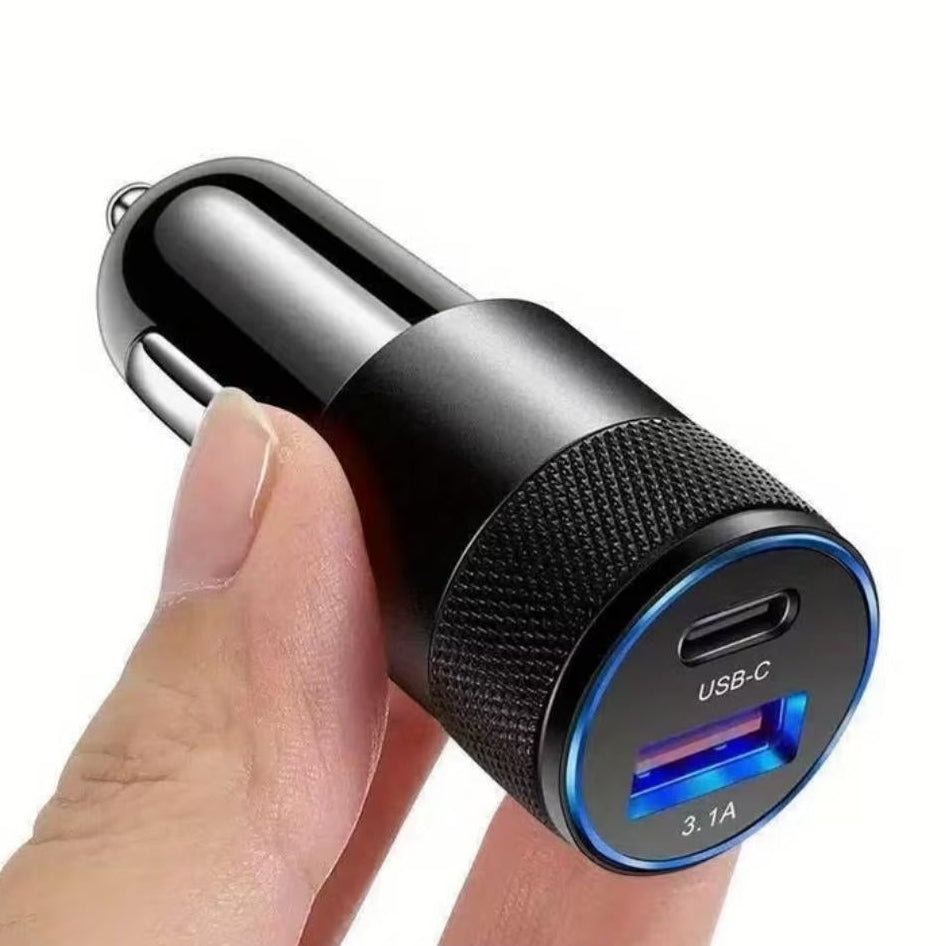Black car charger with USB-C and USB-A ports held by a hand on a white background